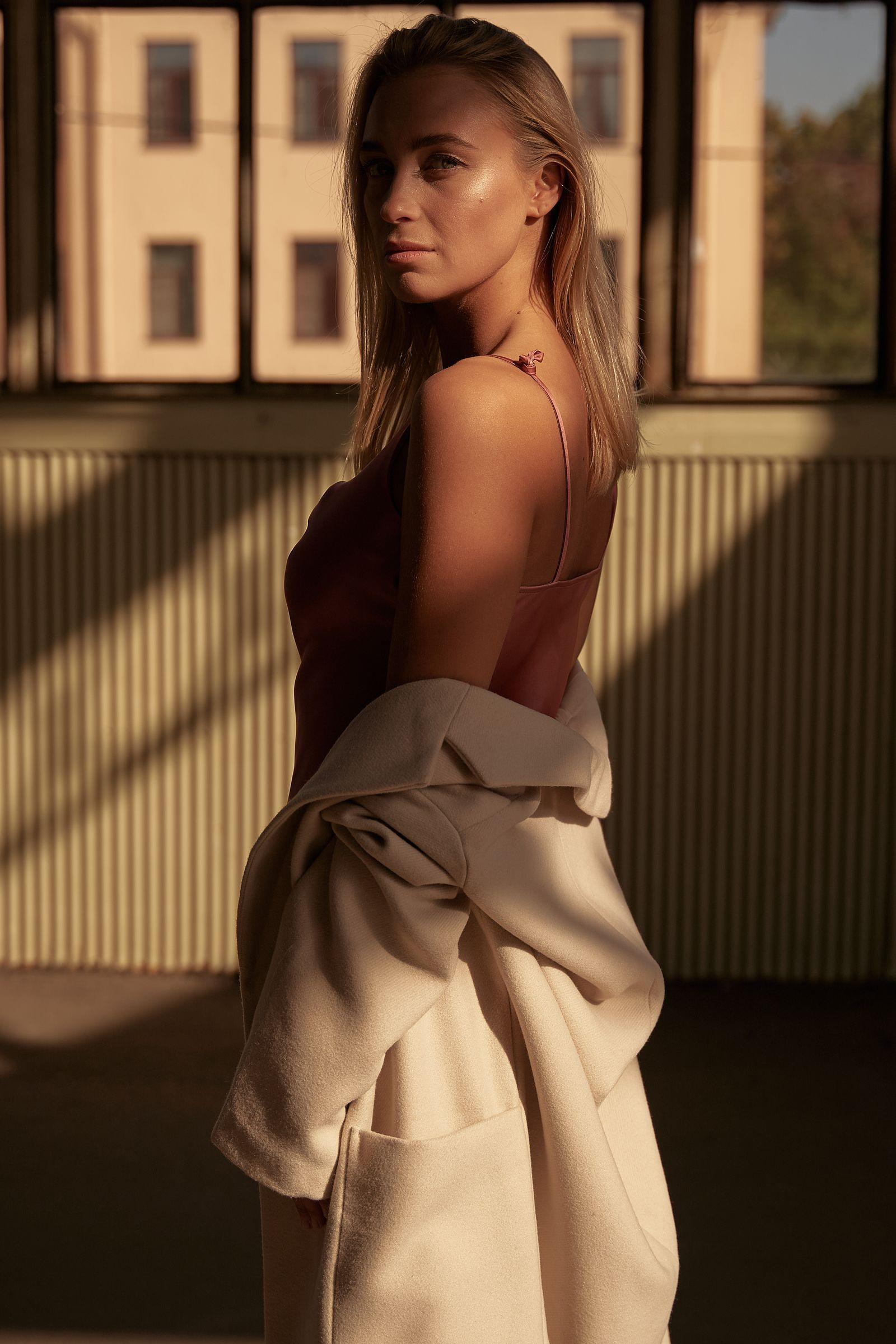 A single tailored coat, photographed in soft natural light