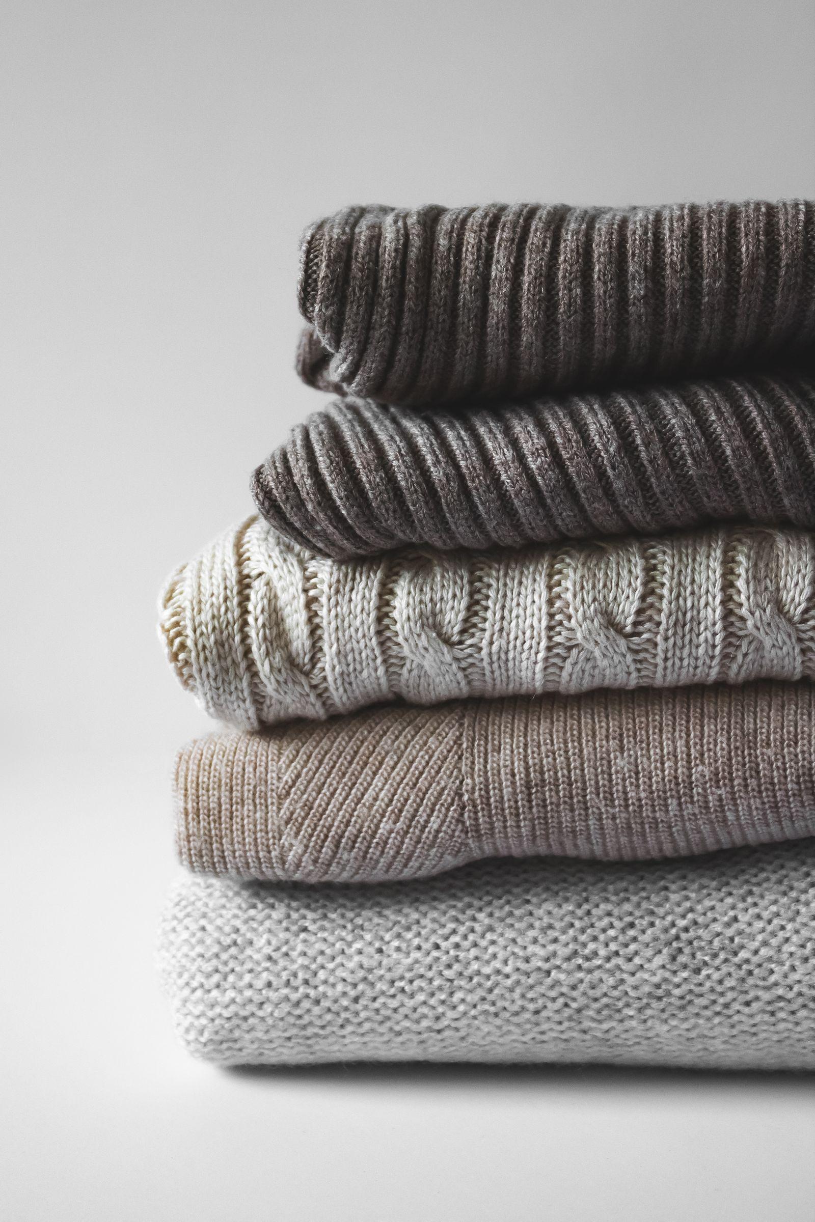 A stack of knitted sweaters