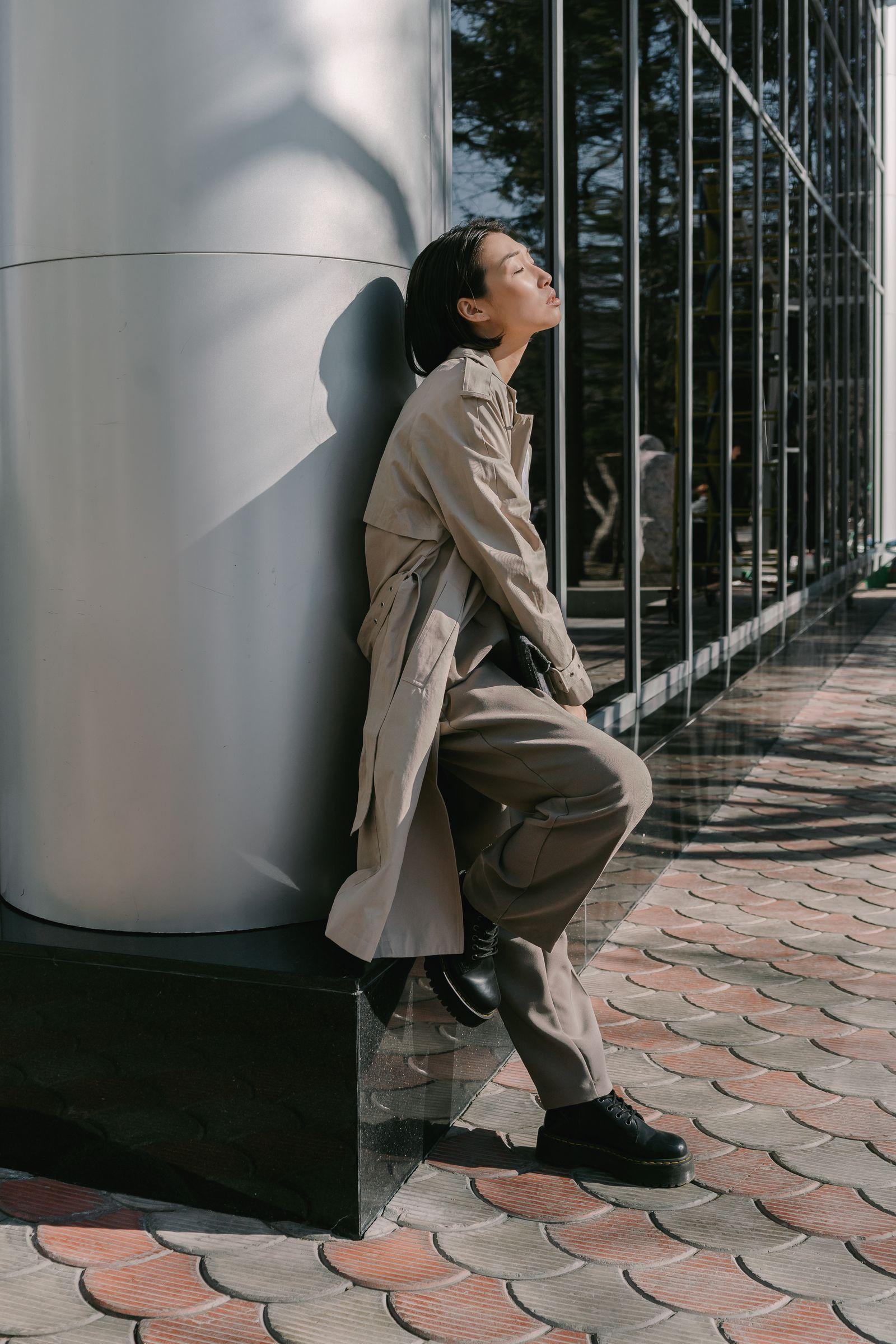 A coat worn against a plain wall, caught in low light