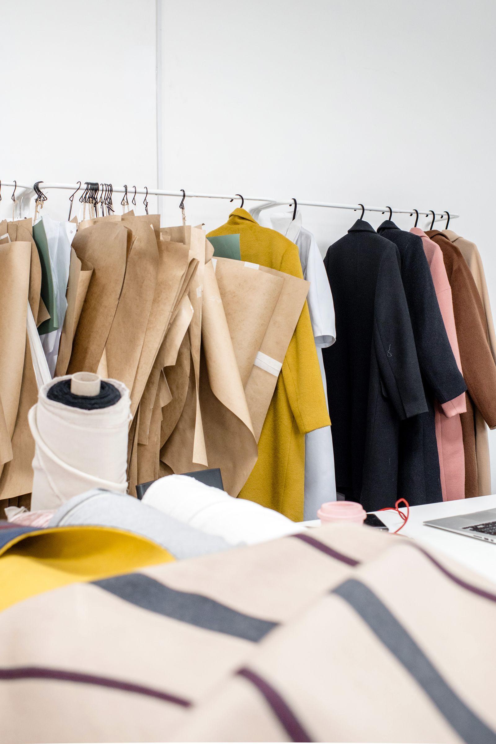 Garments and fabric samples arranged in the workshop