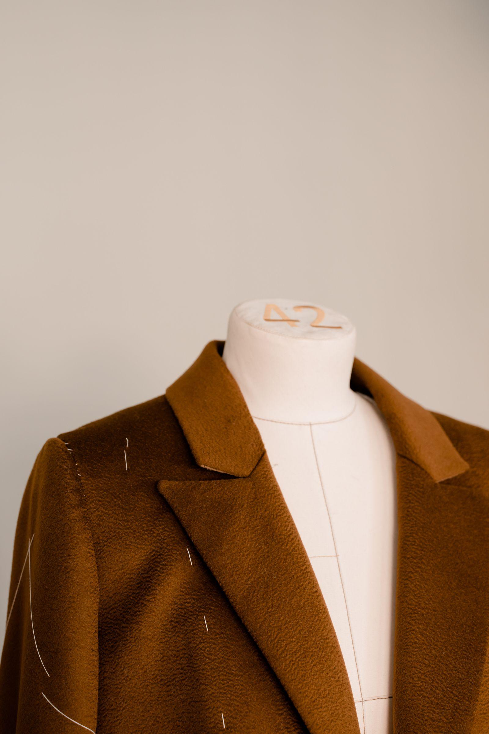A tailored blazer, photographed on a mannequin in the workshop